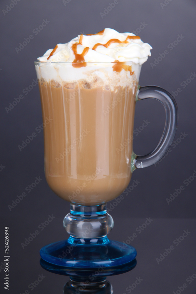 Layered coffee in glass on table on grey background Layered coffee in glass on table on grey background