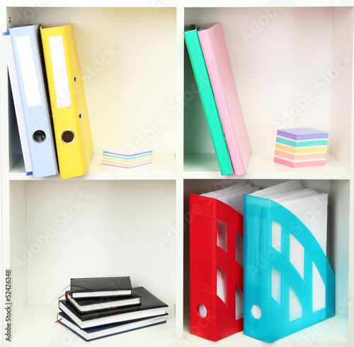 White office shelves with different stationery, close up