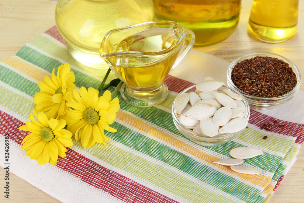 Useful linseed oil and pumpkin seed oil on wooden table Useful linseed oil and pumpkin seed oil on wooden table