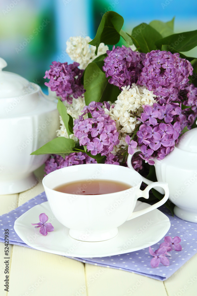 Composition with beautiful lilac flowers, tea service Composition with beautiful lilac flowers, tea service