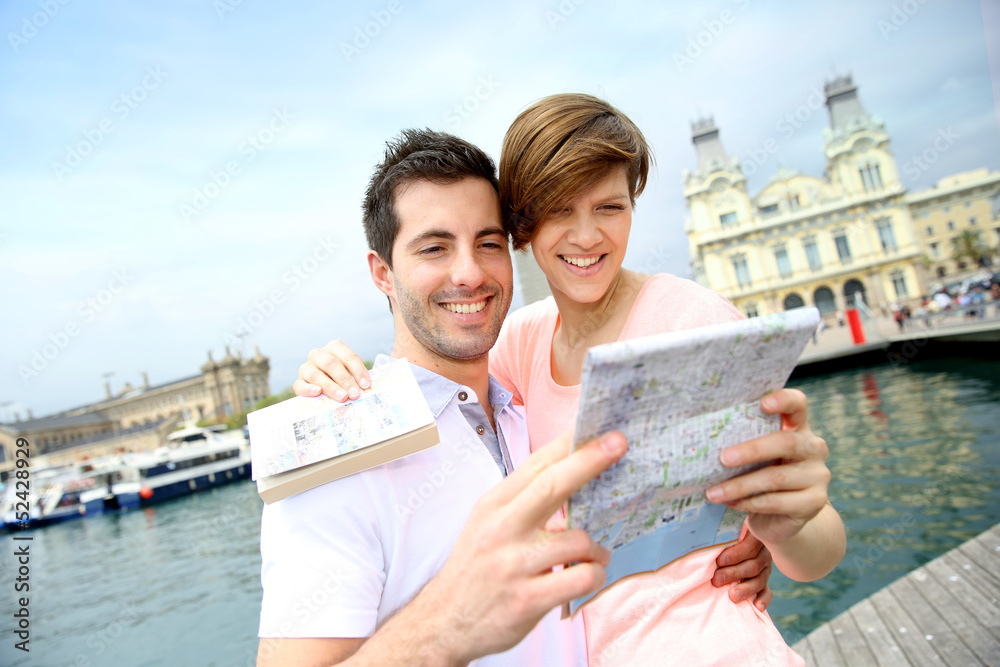 Couple reading touristic map in Barcelona
