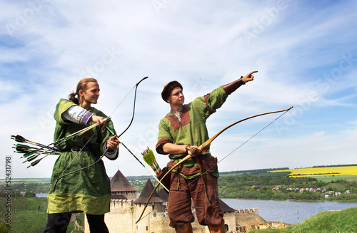 Archers with bows and arrows in medieval costumes