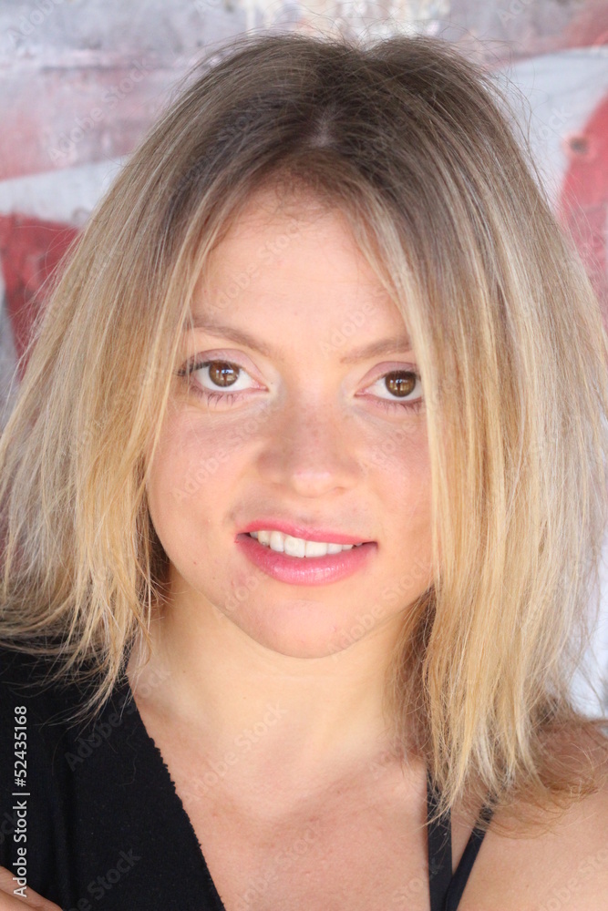 Beautiful blond portrait, near a graffiti wall Beautiful blond portrait, near a graffiti wall