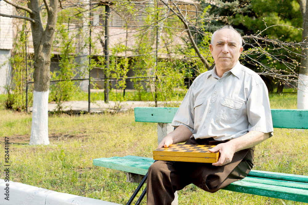 Senior amputee sitting on a park bench