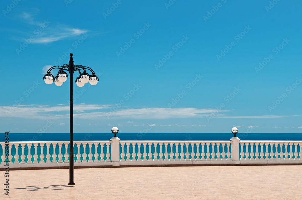beautiful promenade with lanterns and white railings