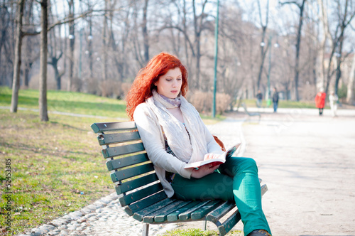 beautiful red head young woman reading book