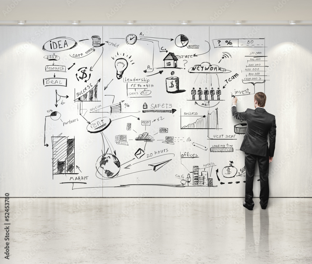 businessman drawing business strategy on the wall businessman drawing business strategy on the wall