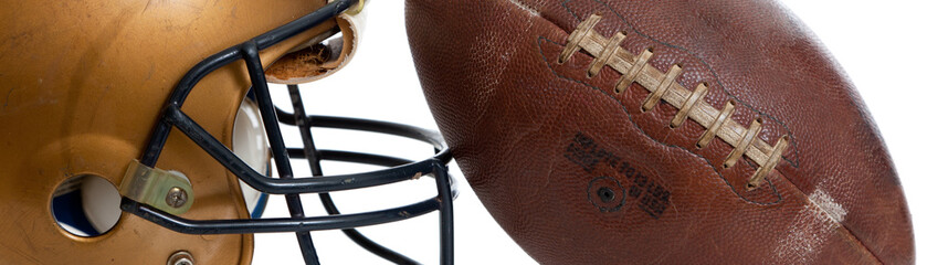 A retro gold football helmet and football on a white background