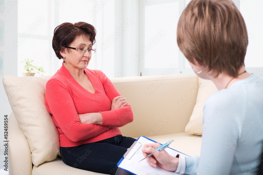 An elderly woman talking to psychologist An elderly woman talking to psychologist