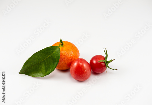 one orange and two tomatoes on the white background