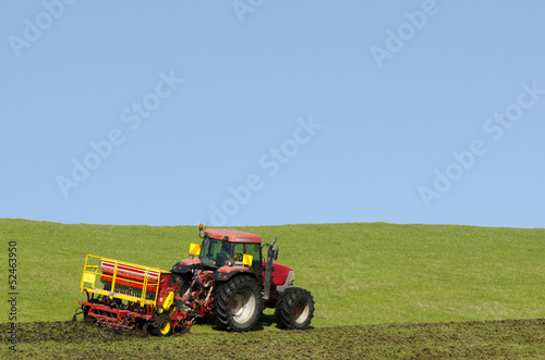 Tractor plowing the ground photo