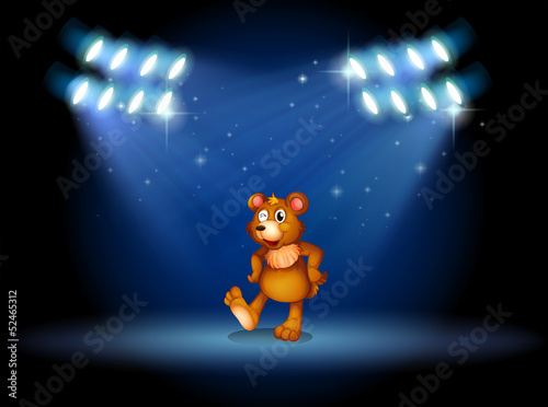 A stage with a bear dancing at the center