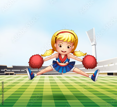 A young cheerdancer performing at the field