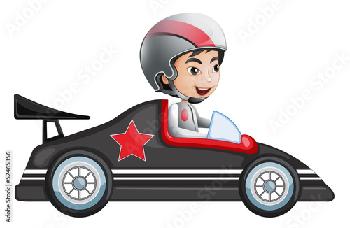 A young boy riding in his racing car