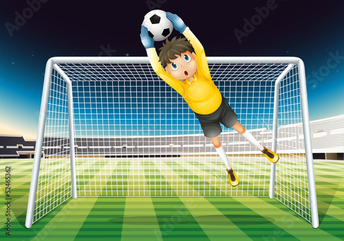 A boy catching the soccer ball