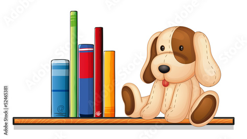 A shelf with books and a toy