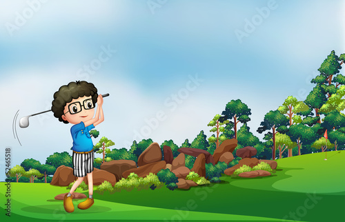 A boy playing golf at the forest