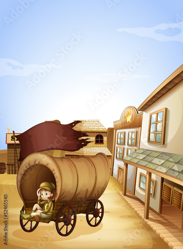 A little girl sitting in the wooden carriage
