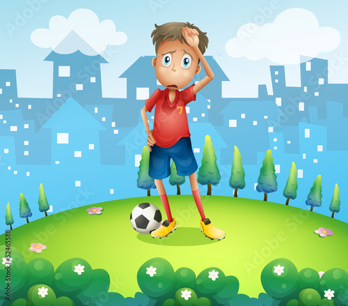 A tired soccer player at the top of the hill