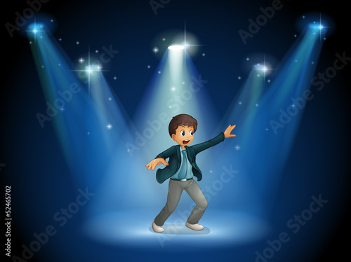 A stage with a boy dancing at the center