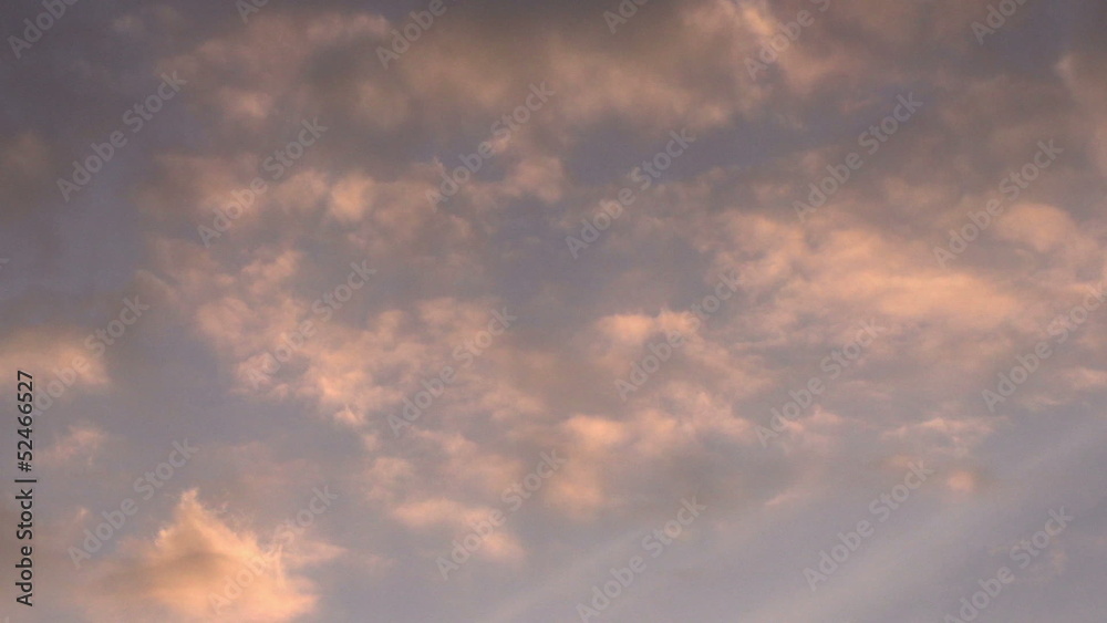 Clouds illuminated by the setting orange sun. Time-laps 50X