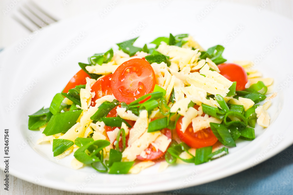 Fresh vegetable salad with cherry tomatoes, green onions, cheese