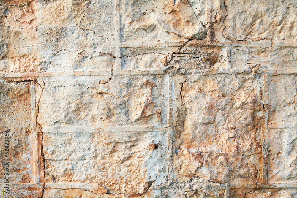A weathered natural sandstone brick wall
