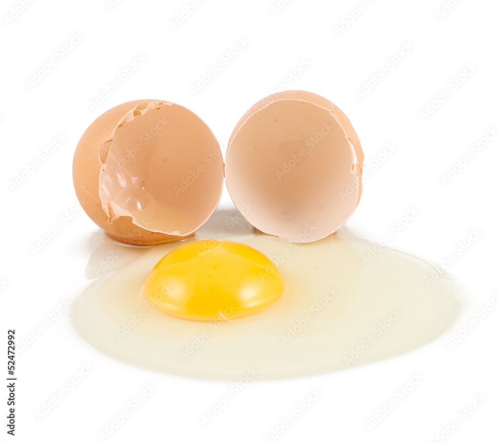 Cracked egg shell with yolk and protein Cracked egg shell with yolk and protein
