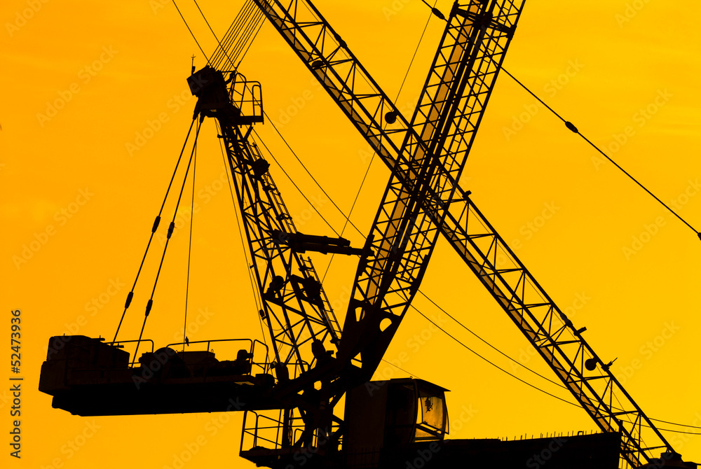silhouette of the tower crane on the construction site