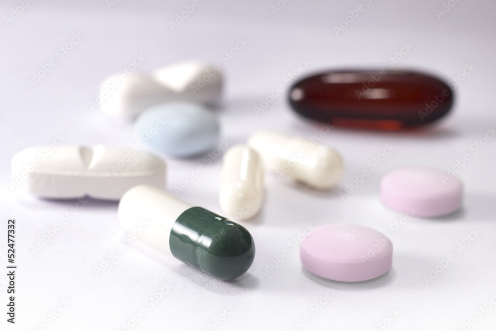 various pills on white background various pills on white background