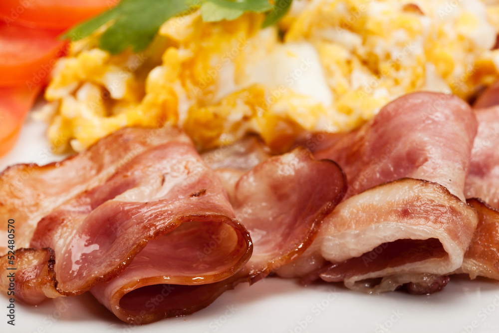 Closeup of scrambled eggs with bacon. Selective focus. Closeup of scrambled eggs with bacon. Selective focus.