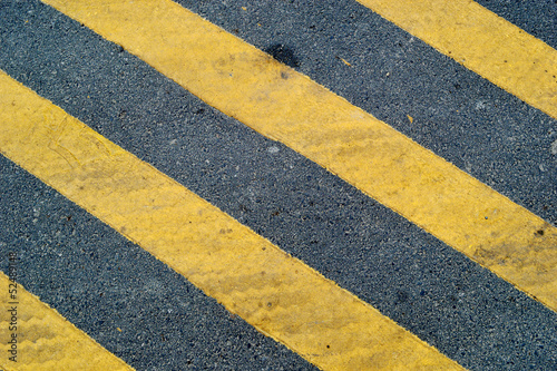 Asphalt road with yellow stripe