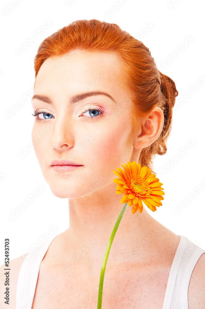 Woman with orange flower near her face on white background