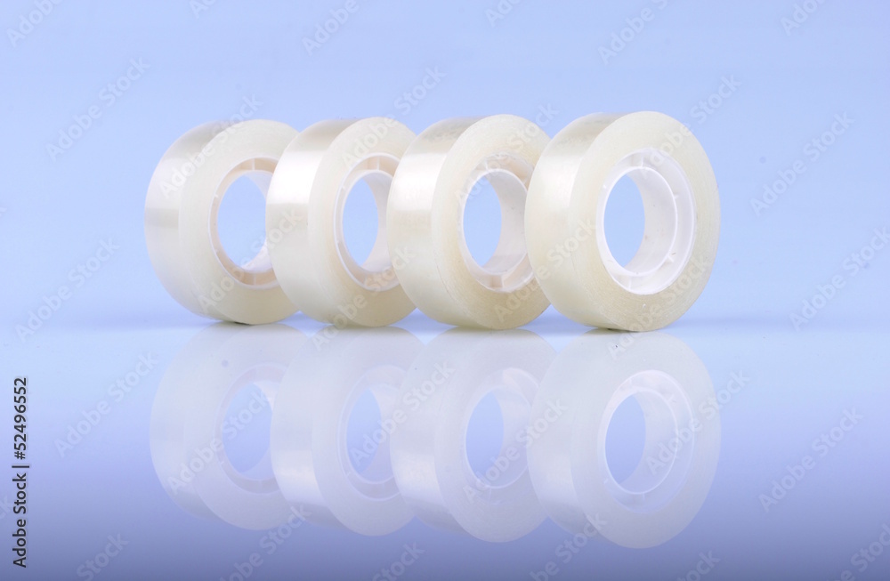 Transparent scotch tape rolls in a row Transparent scotch tape rolls in a row