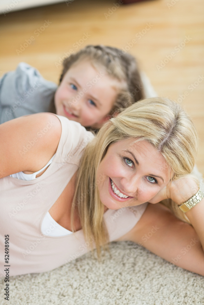 Mother and daughter resting on floor Mother and daughter resting on floor