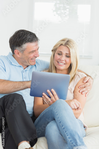 Wife and husband using tablet pc together