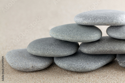The group of stones lies on small sea sand