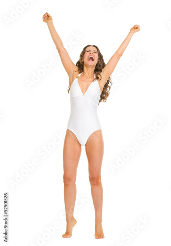 Portrait of happy young woman in swimsuit rejoicing