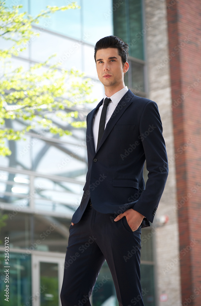Handsome businessman walking outdoors Handsome businessman walking outdoors