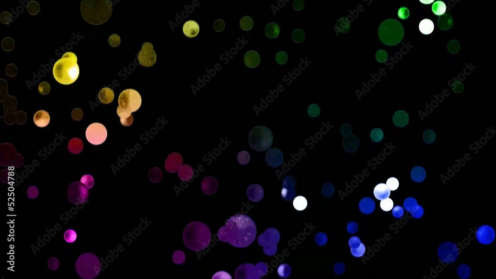 Paillettes brillantes multicolores qui montent sur fond noir