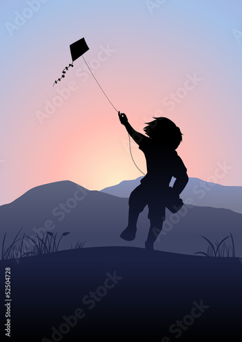 A boy playing a kite in the beautiful morning scene