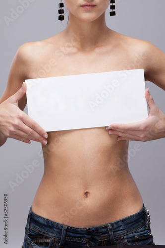 Beautiful, female torso with a sign
