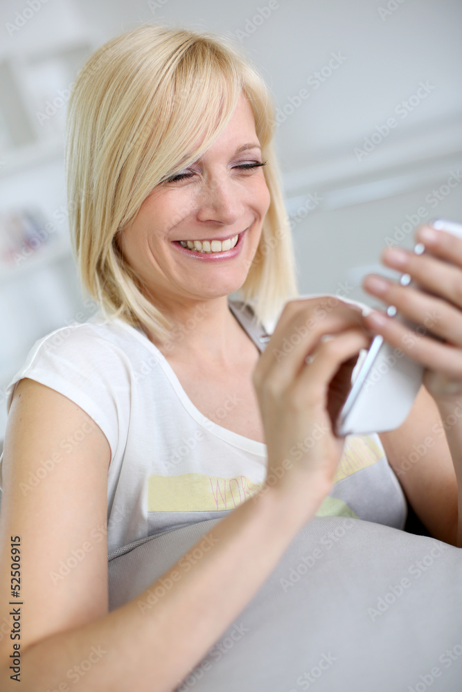 Cheerful girl using smartphone Cheerful girl using smartphone