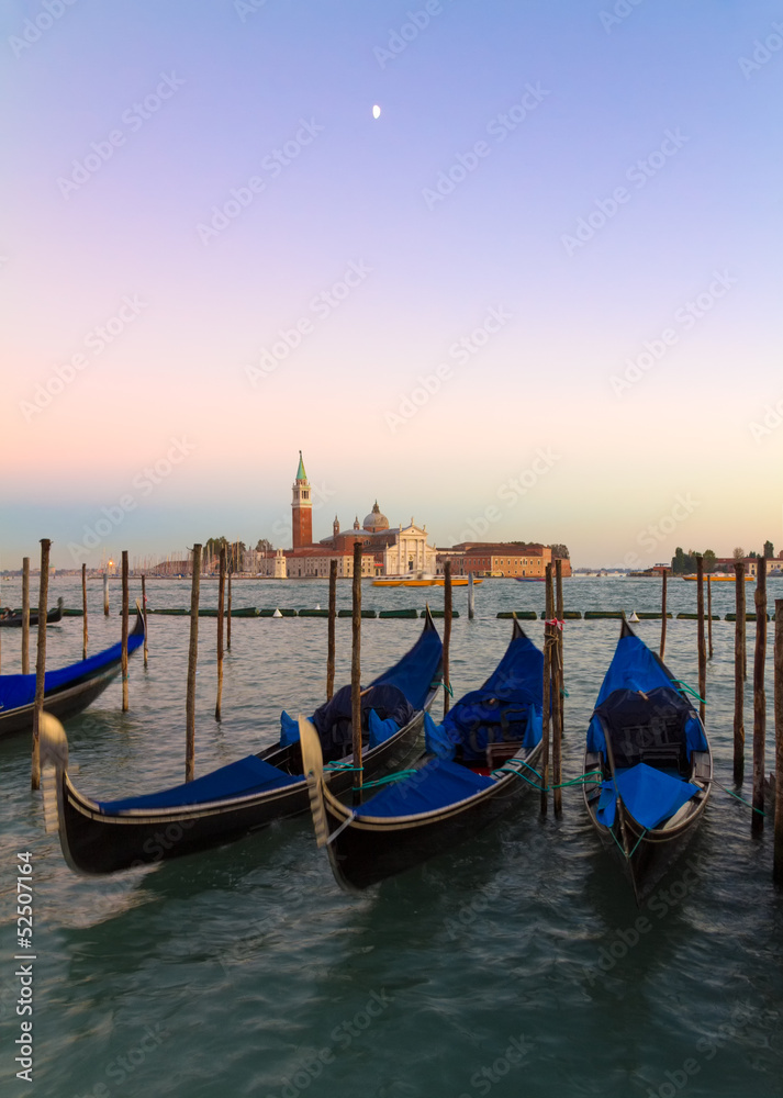 Gondolas at sunset with San Giorgio di Maggiore church, Venice,