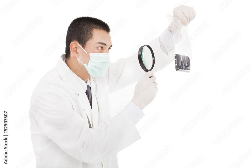 young investigator watching the evidence by magnifier young investigator watching the evidence by magnifier