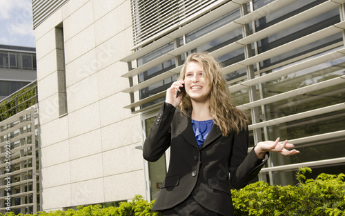 Young bussines woman with modern office in her background