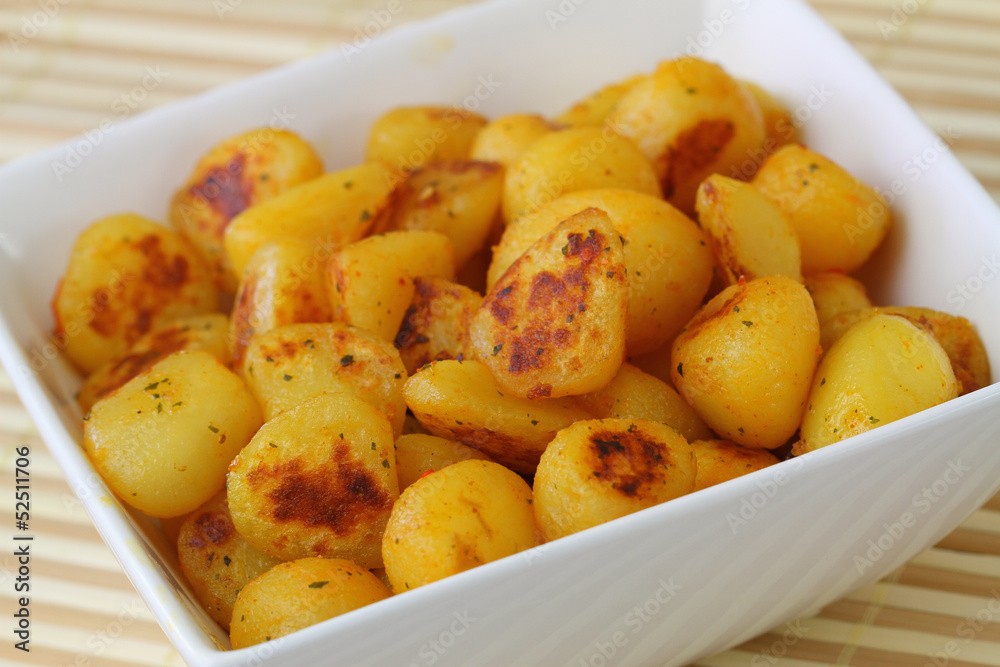 Fried baby potatoes with spices, close up