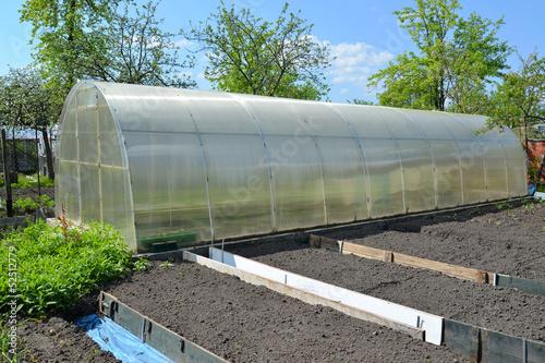 The greenhouse from cellular polycarbonate on a country section photo
