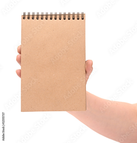 a hand holding a recycled notebook, isolated on white background