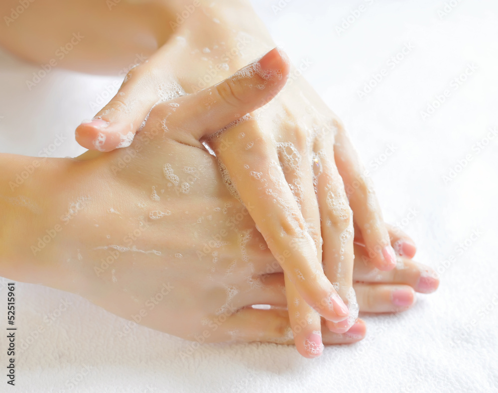 Fototapeta premium Washing woman hands on a background a white towel